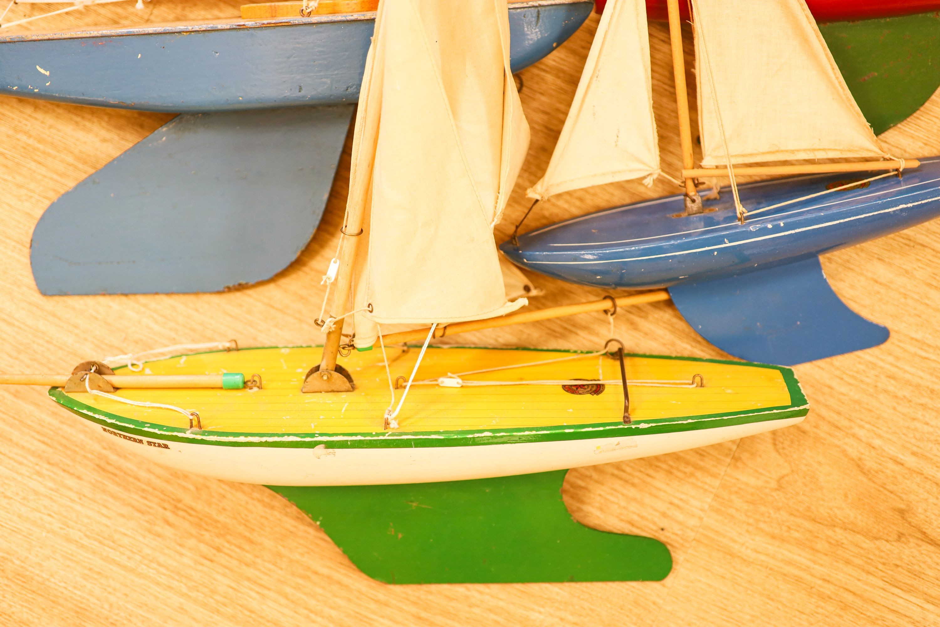 A group of five painted wood pond yachts